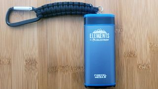 Review photo of the Celestron Elements FireCel Mega 6 power bank on a bamboo table