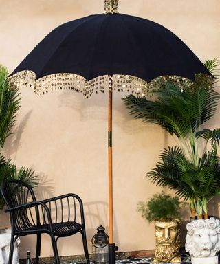 black garden parasol with tassels