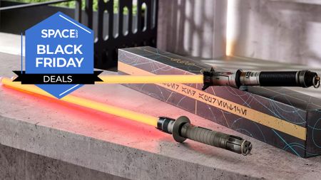 Two metal lightsabers with red glowing blades are displayed on a marbel surface.