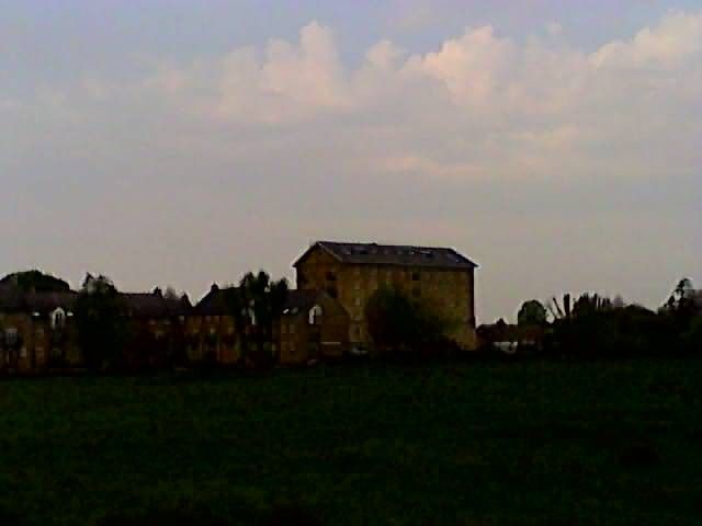 cheap drone poor quality sample image of building and field