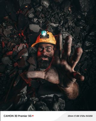 A miner covered in coal in Iraq