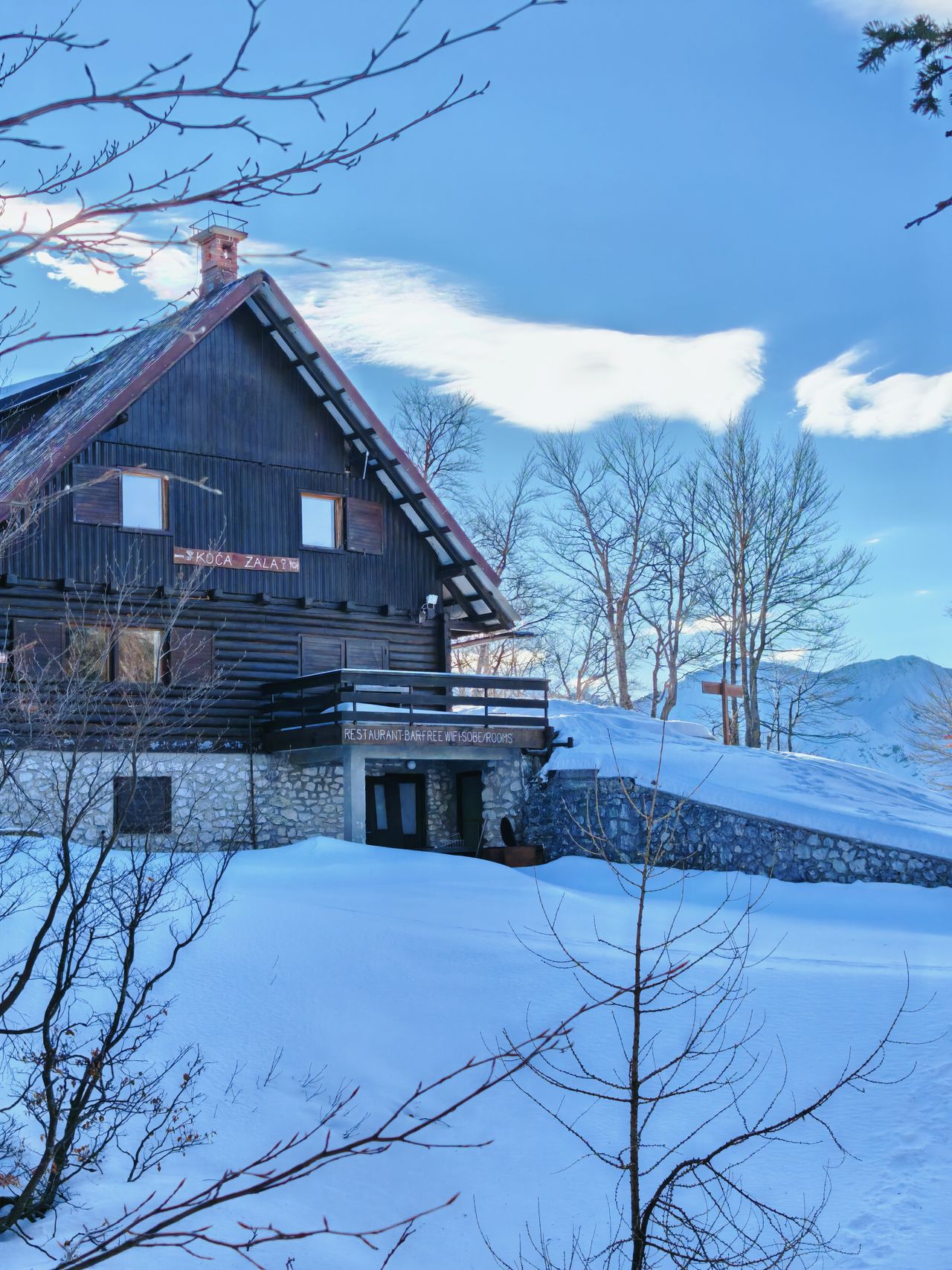 A wooden building surrounded by snow