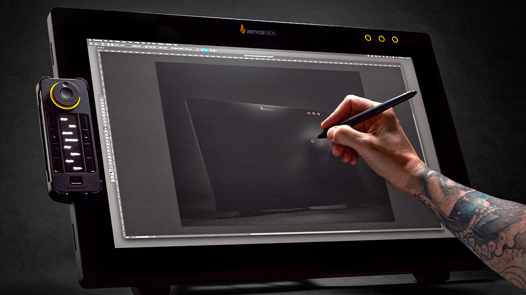 Xencelabs Display 24 Studio Series; a hand holds a pen stylus and uses a large drawing tablet
