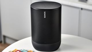 A black Sonos speaker sat on a kitchen table