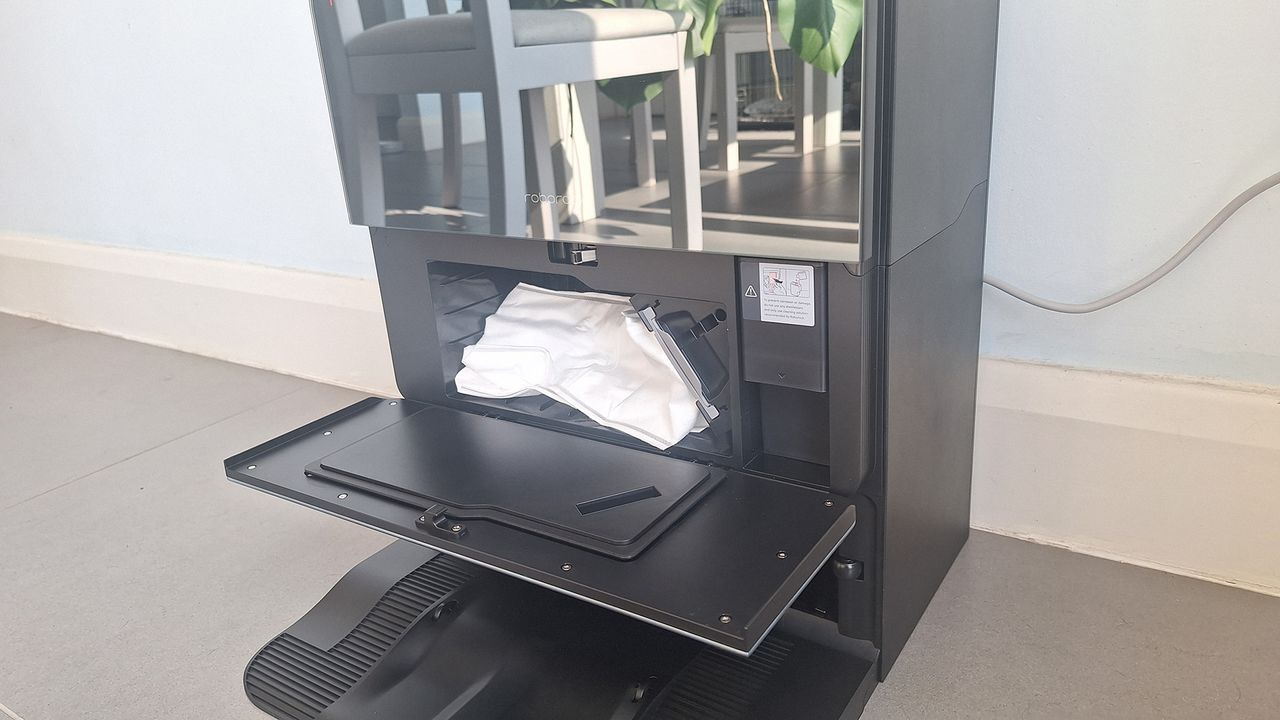 Roborock Saros 10 dock with front door open to show dust bag