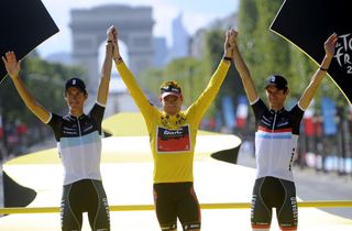 Frank and Andy Schleck flank Cadel Evans on the podium of the 2011 Tour de France
