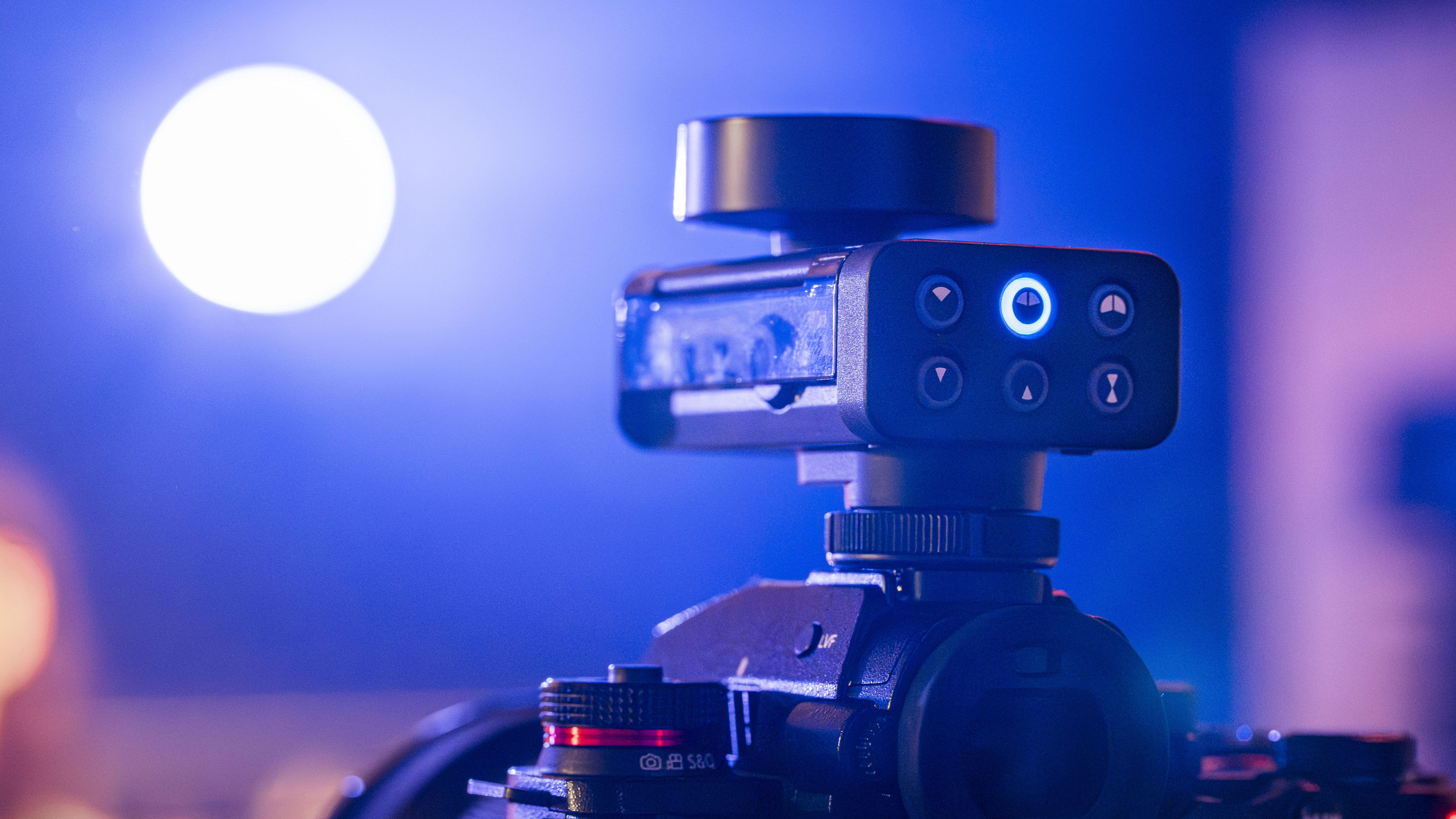 Close-up of the Lumix DMW-DMS1 digital shotgun microphone mounted on a camera, showing illuminated directional control buttons.