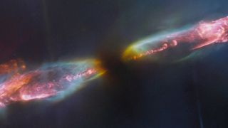 Against the dark backdrop of space, a vibrant, colorful view of jets making a diagonal line from the top right corner of the image to the bottom left. 
