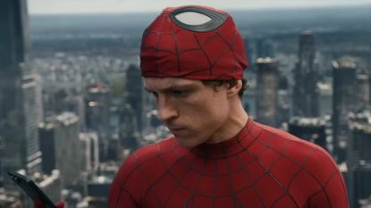 Tom Holland as Spider-Man looking at a phone in Spider-Man: Brand New Day