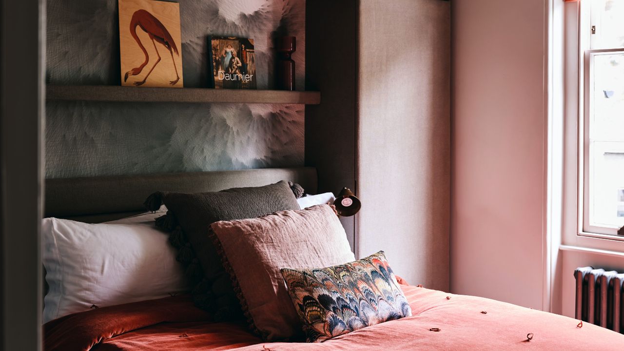 Dark bedroom bedding and cusions with shelf above headboard