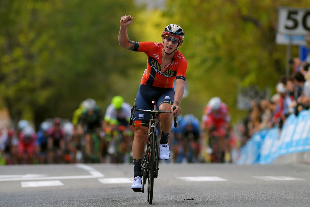 Ivan Garcia Cortina (Bahrain-Merida) celebrates his teammates win just ahead of the peloton
