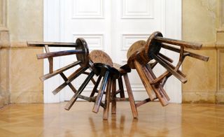 sculpted balancing wooden stools