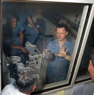 NASA photographer Terry Slezak shows his colleagues the lunar dust on his fingers after he picked up a film magazine that Buzz Aldrin dropped on the moon.