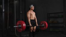 Man doing deadlift with barbells