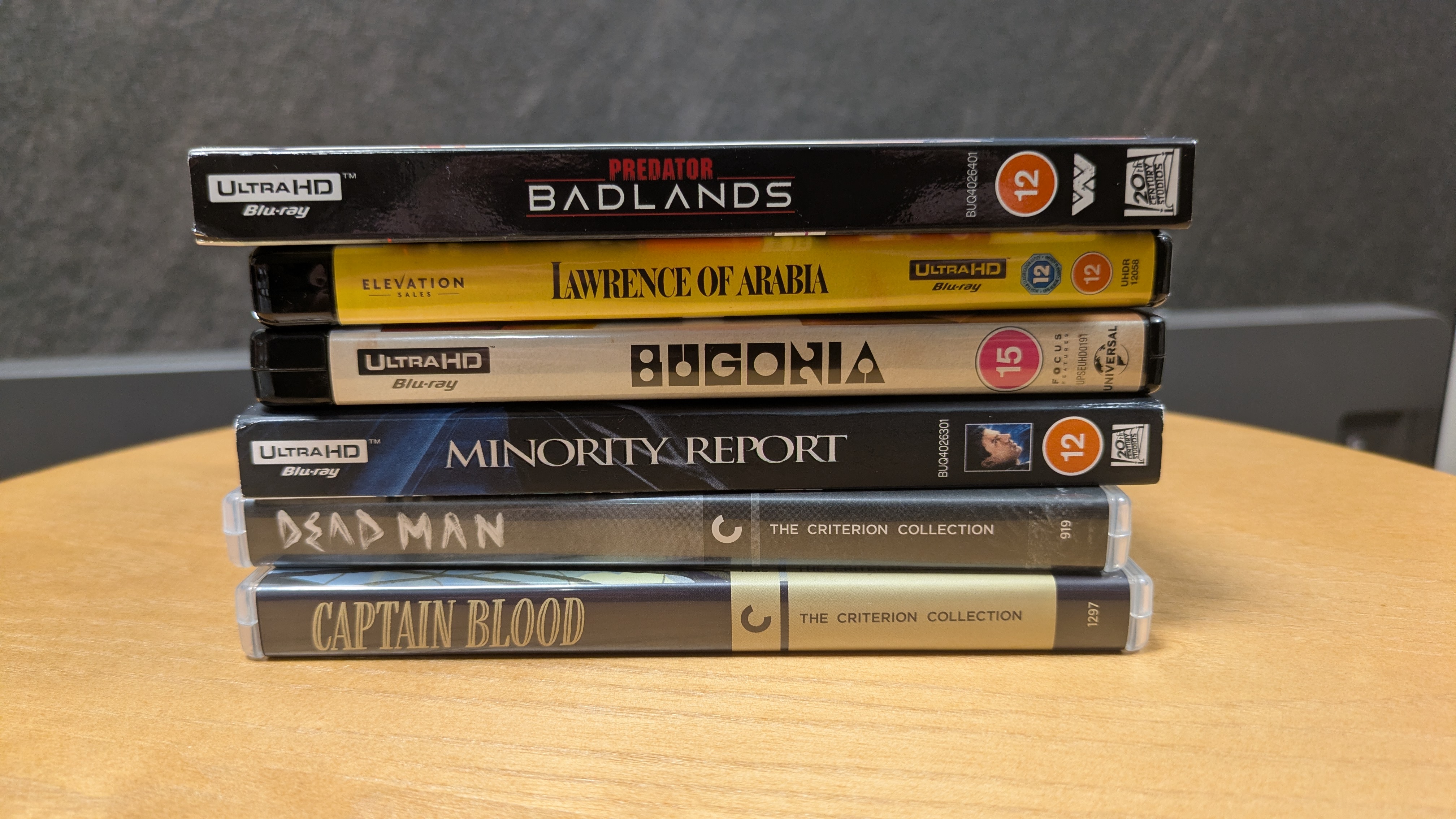 4K Blu-ray collection hero image with Minority Report, Lawrence of Arabia, Bugonia, Predator: Badlands, Dead Man and Captain Blood 4K Blu-ray cases in a pile 