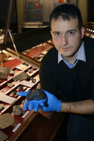 Meteorite scientist Ludovic Ferrière holds a chunk of Chelyabinsk skyfall at the Natural History Museum in Vienna.