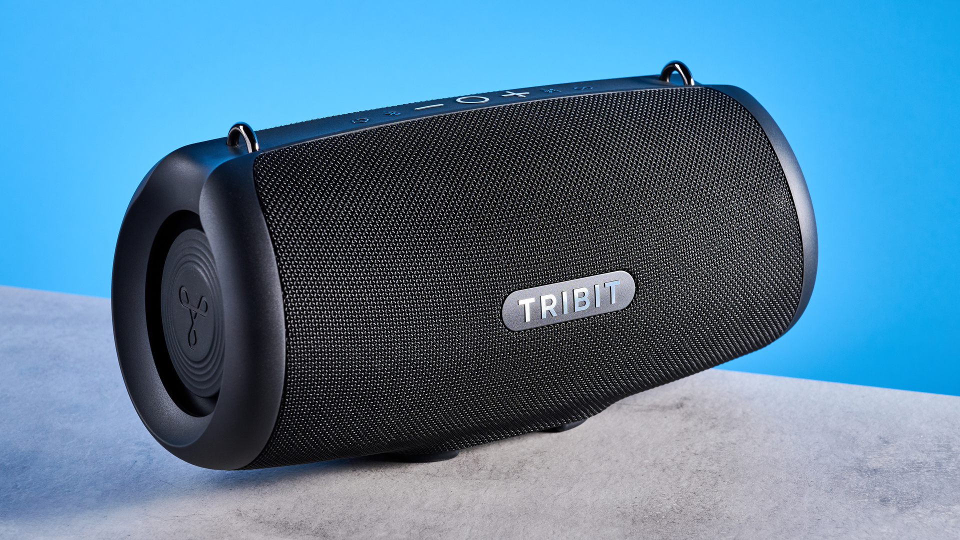 Tribit StormBox Lava Bluetooth Speaker photographed in front of a blue background.
