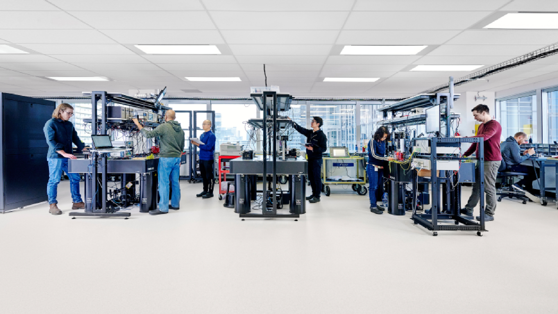 People working at desks in a wide shot of Xanadu's lab