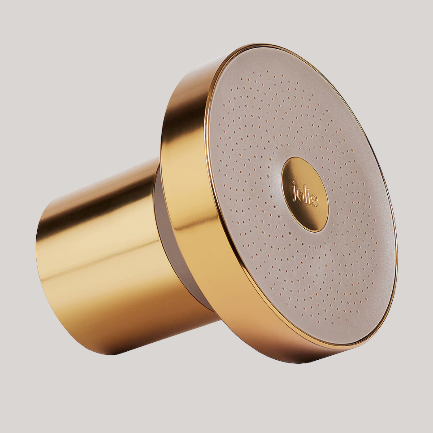 A brushed gold filtered showerhead against a gray backdrop