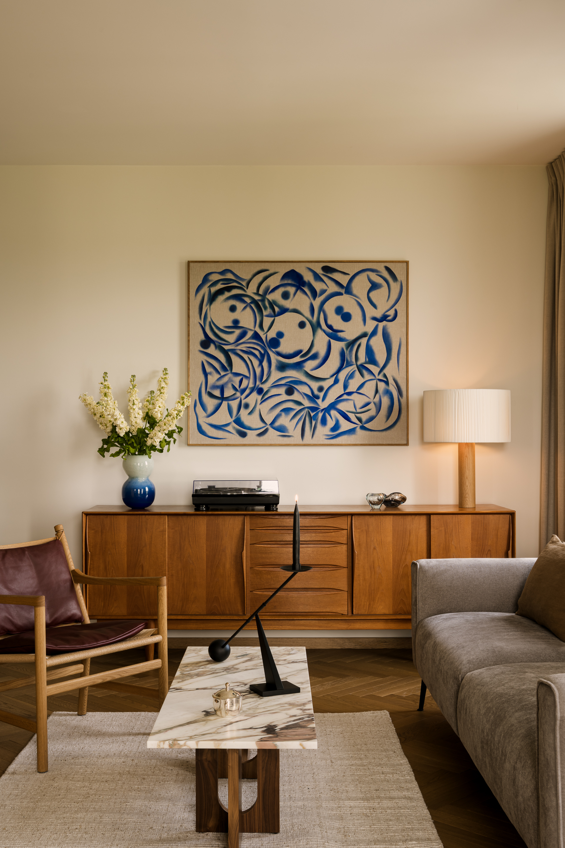 A contemporary living room with a mid-century sideboard framing the seating area