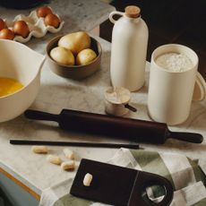 H&M cooking collection with mango wood rolling pin, ceramic oil pourer and mixing bowl on a marble worktop