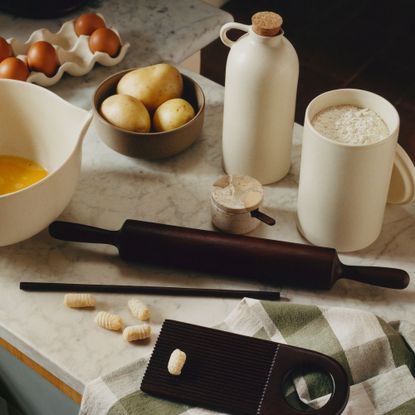 H&M cooking collection with mango wood rolling pin, ceramic oil pourer and mixing bowl on a marble worktop
