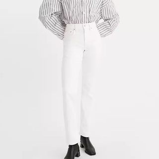 Cropped image of woman wearing Levi's white jeans