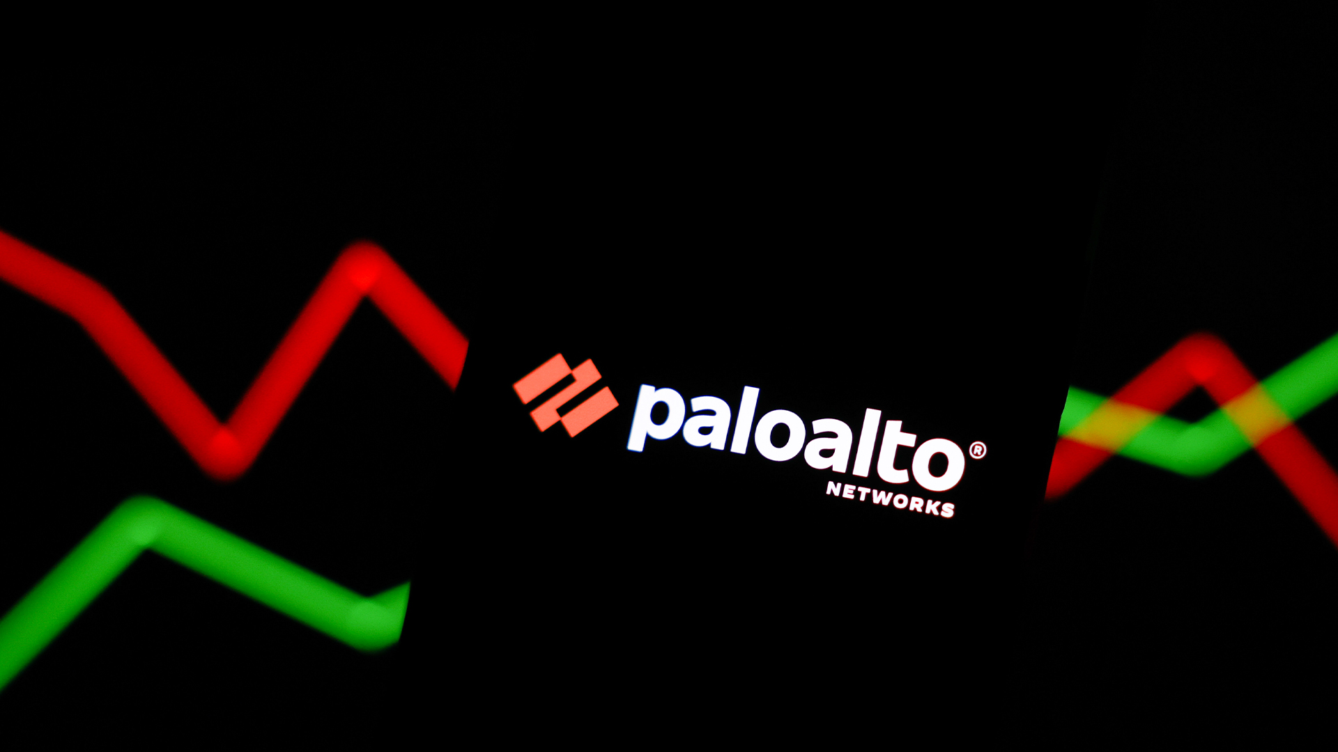 Palo Alto Networks logo and branding pictured on a smartphone screen with stock market growth graph lines in background.