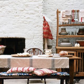 dining room with fireplace and whitewashed brick wall