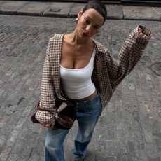 woman wearing dirty denim wash jeans fall denim trend 2025