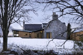 timber clad lean to extension to stone cottage