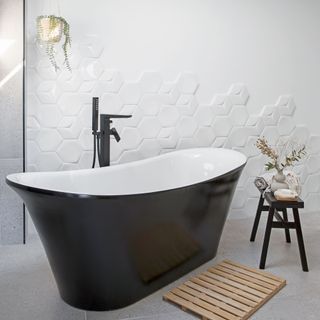 white tiled bathroom with a black modern bathtub