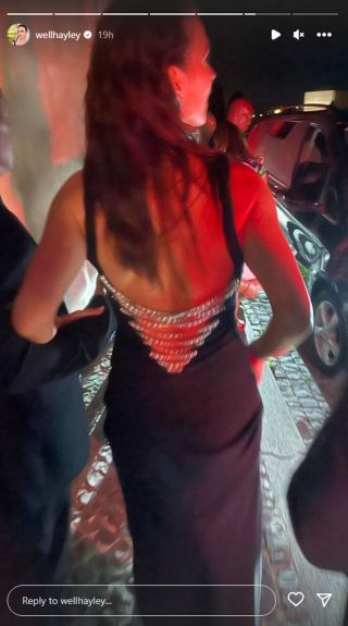 The back of Hayley Atwell's black dress showing an open back with silver chain detail.