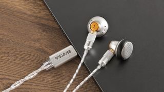 Sivga M260 HiFi wired earbuds in silver on the edge of a laptop