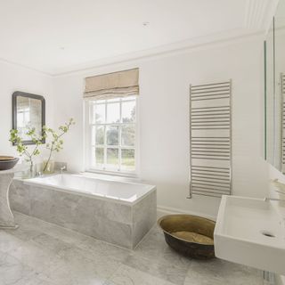 bathroom with tiled flooring and bathtub