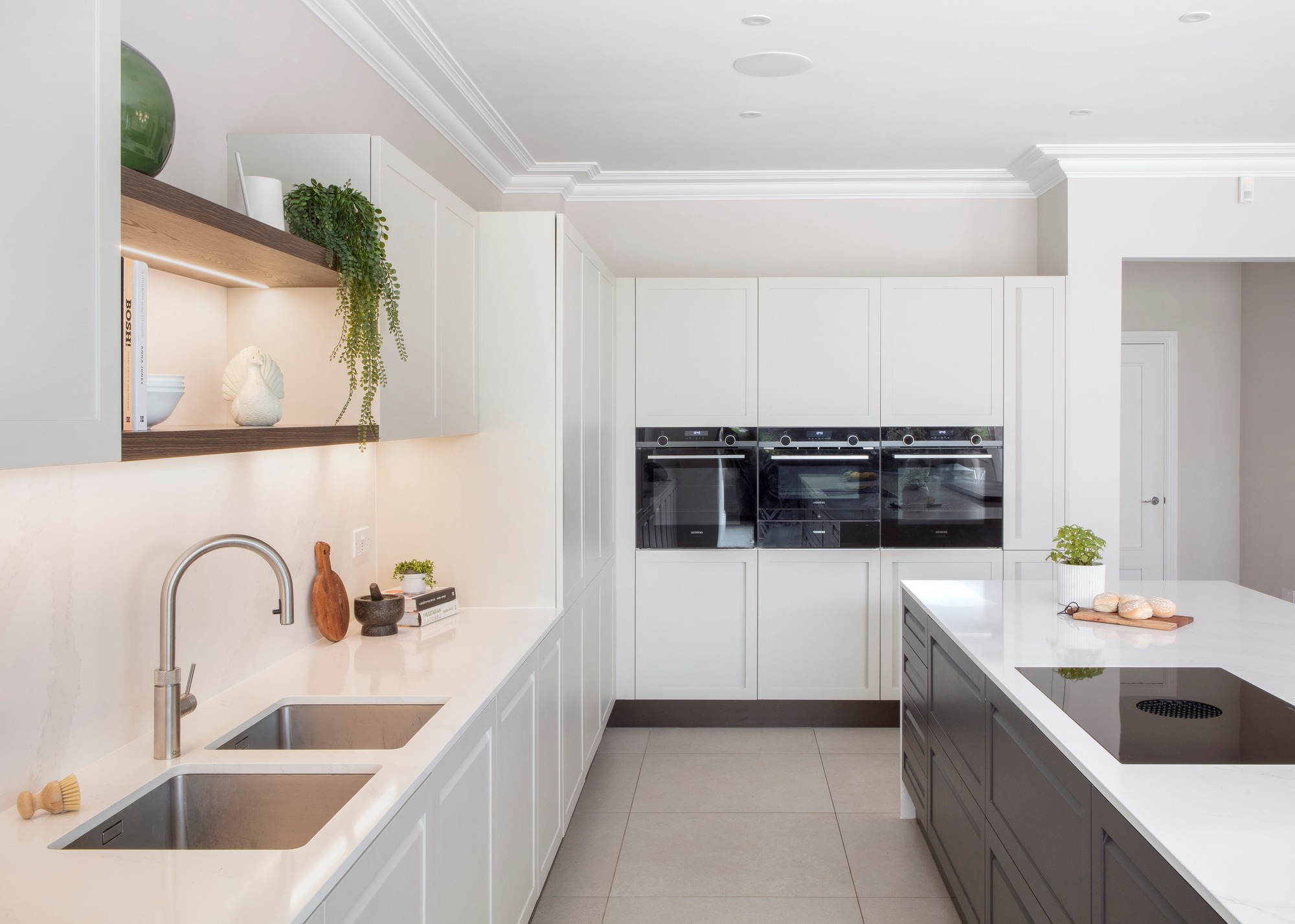 white kitchen with black cabinetry in the island