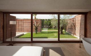 A room with brick walls and garden views