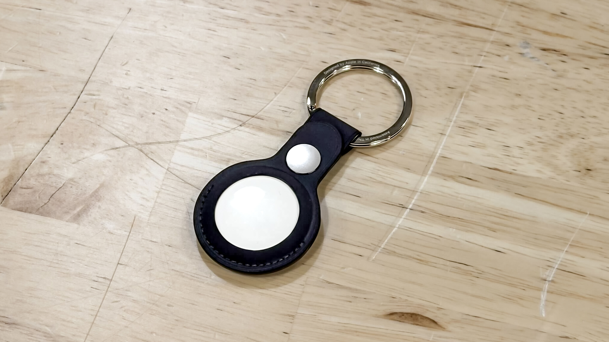 Apple AirTag 2 held in the hand.