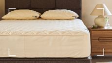 neutral bedroom with an unmade bed showing the woolroom deluxe mattress protector