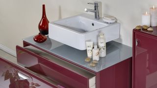 Burgundy vanity unit in a bathroom