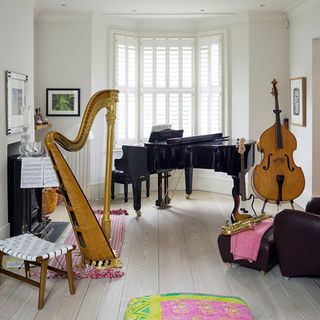 music room with white wall and piano