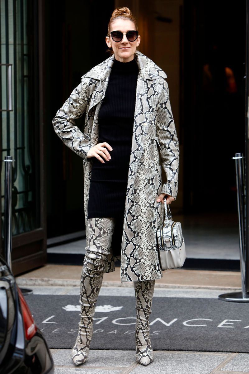 In a snakeskin coat, matching thigh-high boots, and bag while leaving the Hotel Royal Monceau in Paris.