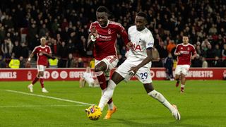 Tottenham Hotspur's Pape Matar Sarr (right) competing with Nottingham Forest's Moussa Niakhate during the Premier League match between Nottingham Forest and Tottenham Hotspur at City Ground on December 15, 2023 in Nottingham, England.