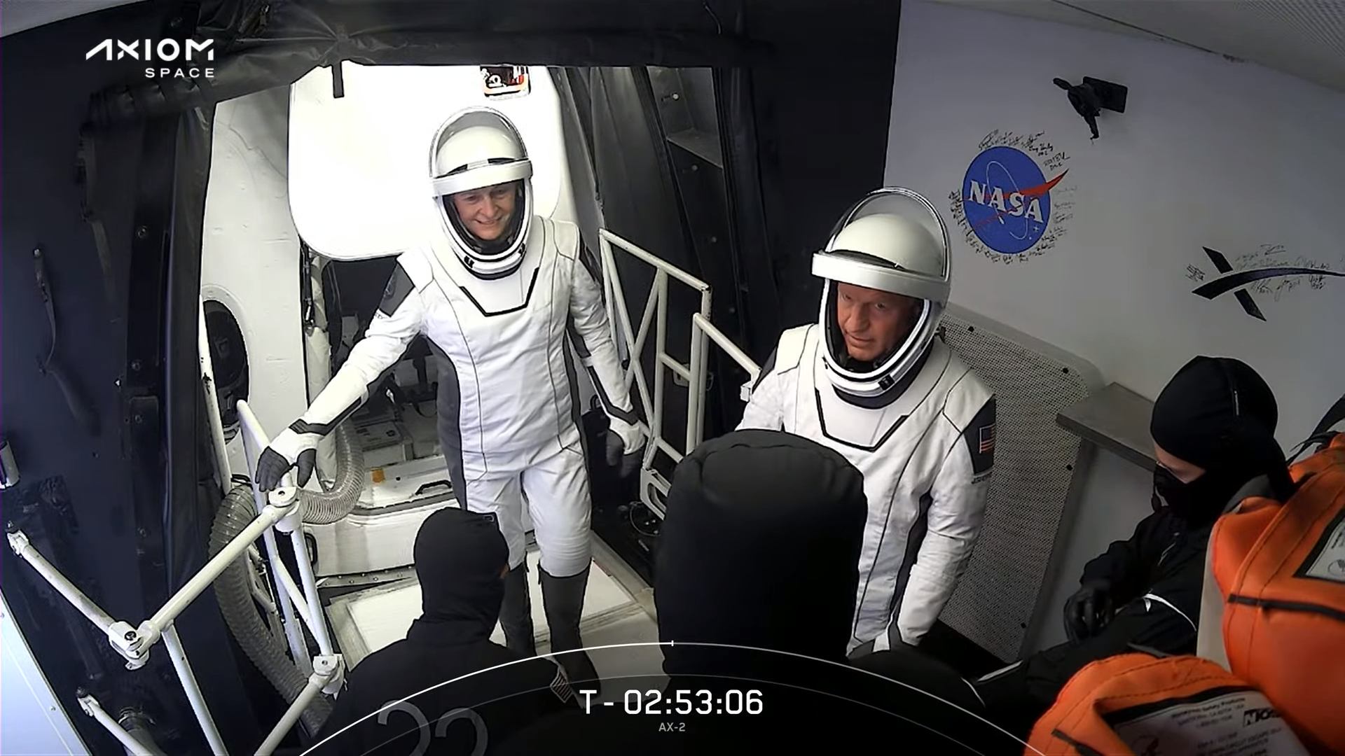 Ax-2 astronauts in spacesuits in Crew Access Arm white room preparing to enter Dragon.