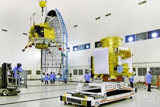 India's Vikram moon lander (left) is moved into launch position on the Chandrayaan-2 lunar orbiter ahead of a planned July 2019 launch. The mission will send an orbiter, lander and rover to the moon.