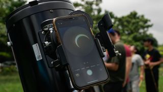 Detail of the sun hidden by the moon in a mobile phone connected to a telescope during an annular solar eclipse on October 14, 2023 in San Salvador, El Salvador.