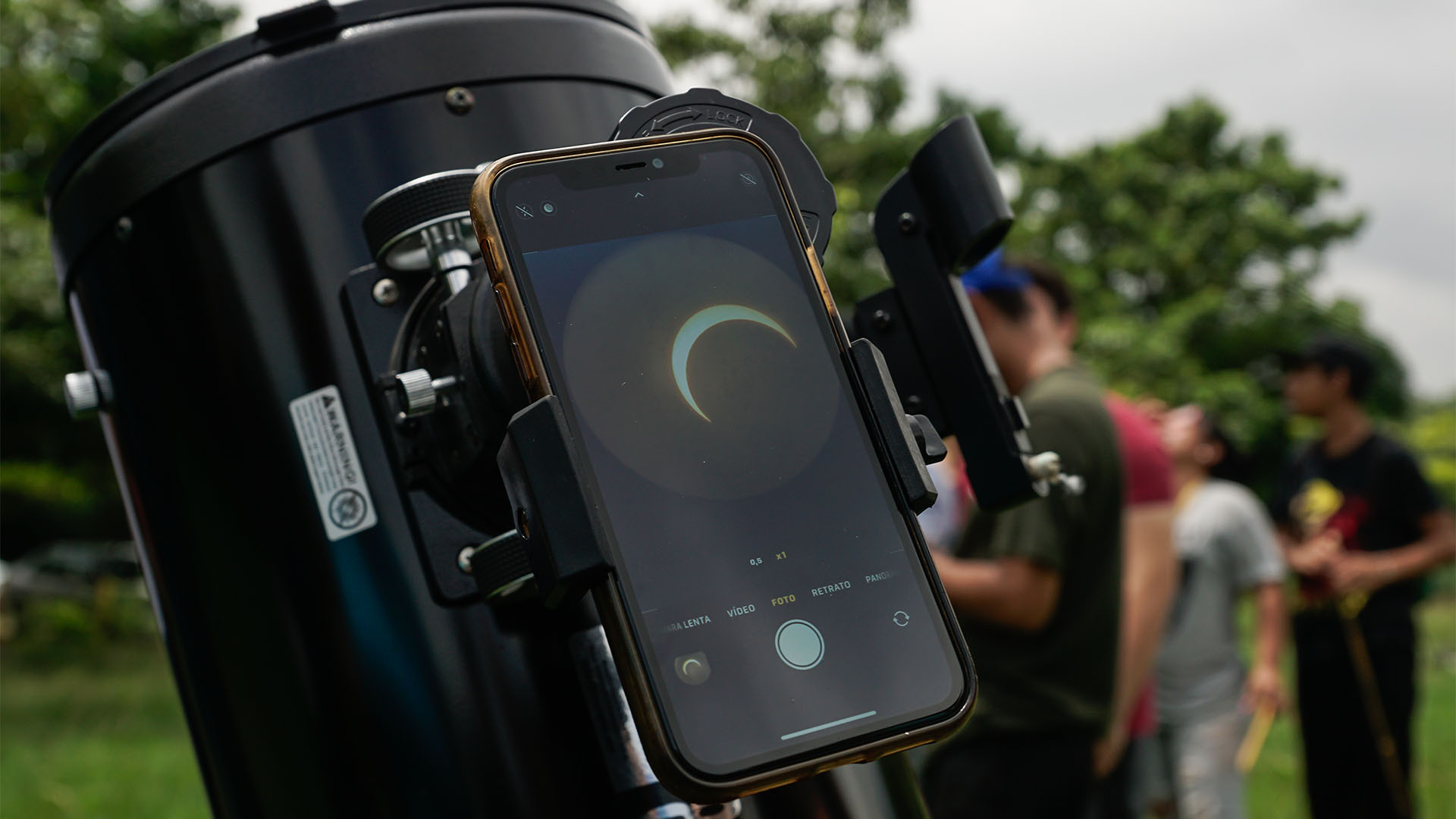 Detail of the sun hidden by the moon in a mobile phone connected to a telescope during an annular solar eclipse on October 14, 2023 in San Salvador, El Salvador.