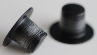 artificial spider silk on a spool