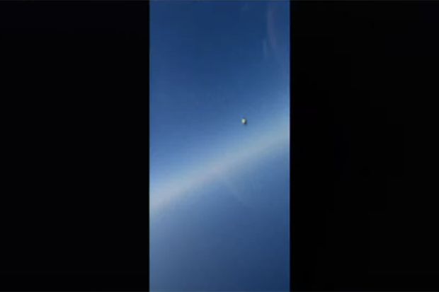 The metallic object can be seen as a tiny blip in split-second footage taken from the US Navy pilot's cockpit.