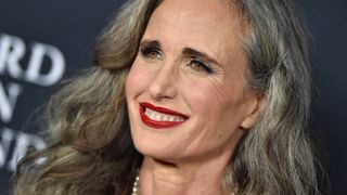 Andie MacDowell wearing navy makeup with red lipstick